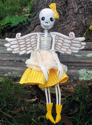 Winged skeleton in yellow